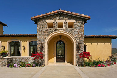 Mid-sized mediterranean multicolored one-story mixed siding exterior home idea in San Diego with a hip roof