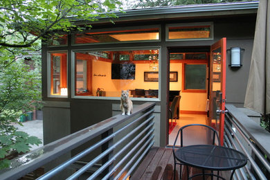 Small modern gray two-story wood exterior home idea in Seattle with a hip roof