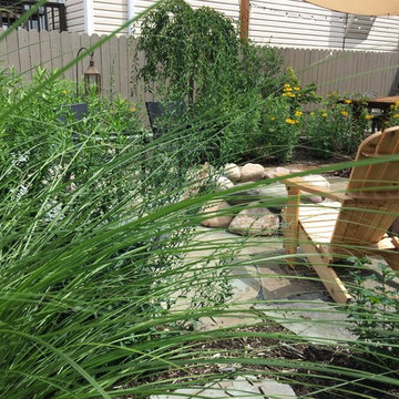 Irregular Bluestone patio with seat wall and boulder firepit, North Center, Chic