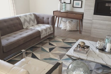 Inspiration for a modern open concept light wood floor living room remodel in Other with a tile fireplace