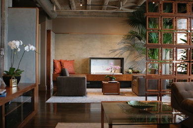 Mid-sized loft-style dark wood floor living room photo in Houston with a ribbon fireplace, a metal fireplace, a media wall and beige walls