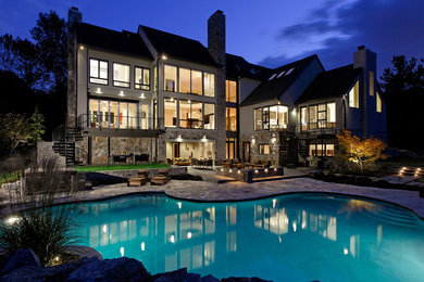 Example of a large trendy beige three-story mixed siding exterior home design in DC Metro