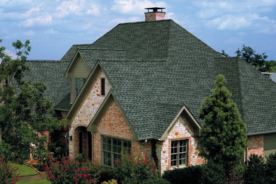 Large elegant multicolored two-story mixed siding exterior home photo in Tampa with a hip roof