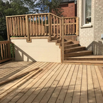 Lower and upper deck levels joined by wide wood stairs in Markham