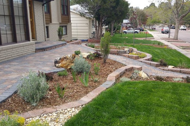 Photo of a mid-sized traditional full sun front yard concrete paver retaining wall landscape in Denver.