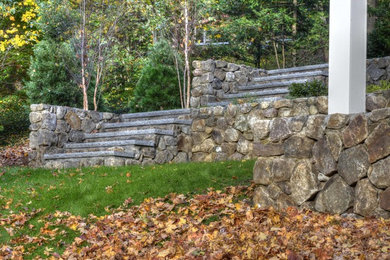 Photo of a large traditional shade backyard formal garden in Boston for fall.