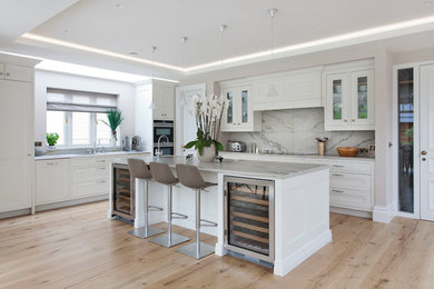 Design ideas for a large transitional kitchen in Other with a drop-in sink, beaded inset cabinets, white cabinets, marble benchtops, white splashback, marble splashback, stainless steel appliances, light hardwood floors, with island and yellow benchtop.