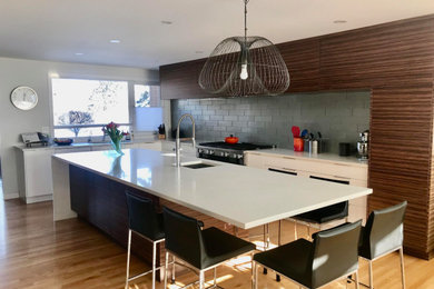 Trendy kitchen photo in Edmonton with flat-panel cabinets, quartz countertops, an island and white countertops