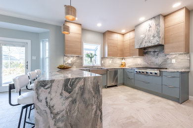 Mid-sized l-shaped open concept kitchen photo in Philadelphia with a peninsula, flat-panel cabinets, light wood cabinets, quartz countertops, gray backsplash, quartz backsplash, stainless steel appliances, gray countertops and a farmhouse sink