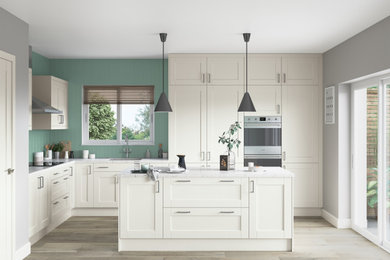 This is an example of a small contemporary l-shaped kitchen/diner in Other with a submerged sink, shaker cabinets, white cabinets, quartz worktops, green splashback, stainless steel appliances, an island and white worktops.