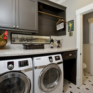 Ejemplo de lavadero multiusos, de estilo americano, pequeño, con armarios con paneles lisos, puertas de armario grises, encimera de granito, paredes grises, suelo de baldosas de cerámica y lavadora y secadora juntas