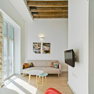 Design ideas for a small mediterranean mezzanine living room in Alicante-Costa Blanca with a music area, white walls, light hardwood flooring and a wall mounted tv.