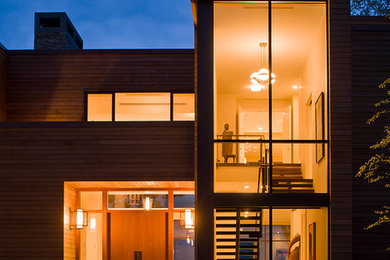 Huge modern brown two-story wood flat roof idea in New York