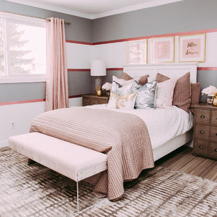 Design ideas for a small transitional guest bedroom in Edmonton with grey walls and laminate floors.