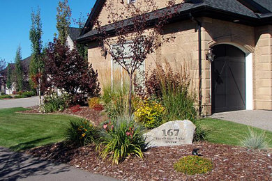 Photo of a mid-sized traditional front yard concrete paver garden path in Edmonton.