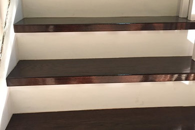 Staircase - traditional wooden curved wood railing staircase idea in Toronto with wooden risers