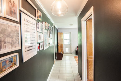 Hallway - mid-sized contemporary ceramic tile hallway idea in Houston with black walls