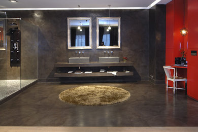 Large trendy 3/4 concrete floor corner shower photo in Barcelona with open cabinets, gray cabinets, gray walls, a vessel sink and concrete countertops