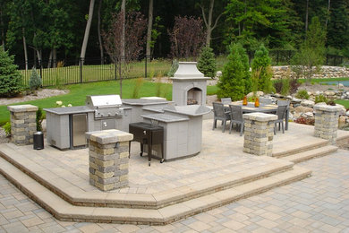 Example of a large concrete paver patio design in Detroit