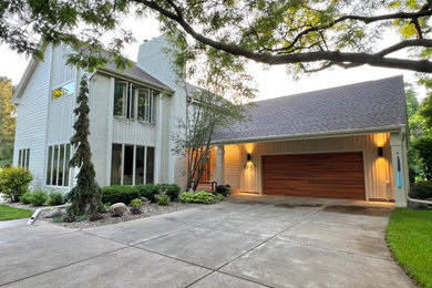 Inspiration for a modern white two-story concrete fiberboard and board and batten exterior home remodel in Minneapolis with a shingle roof and a brown roof