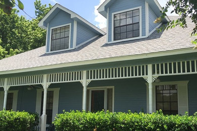 Mid-sized traditional blue two-story vinyl exterior home idea in Houston with a shingle roof