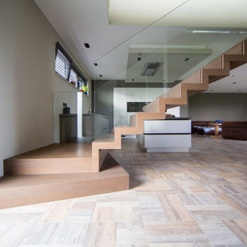 Zig zag staircase in wood with glass balustrade