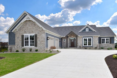 Traditional blue two-story mixed siding and shingle exterior home idea with a shingle roof and a gray roof