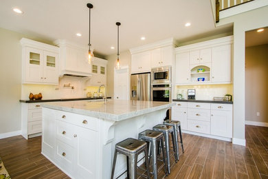 Photo of an arts and crafts kitchen in Salt Lake City with shaker cabinets, white cabinets and with island.
