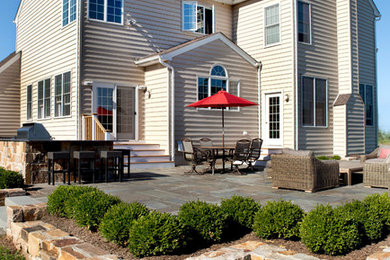 Huge elegant backyard stone patio kitchen photo in New York with no cover
