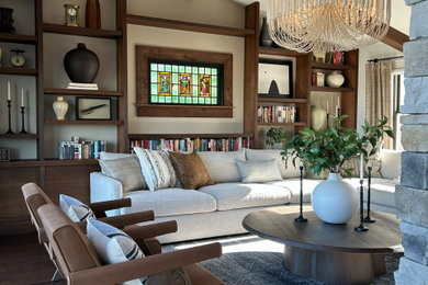 Mid-sized minimalist enclosed dark wood floor, brown floor and exposed beam family room library photo in Other with white walls, a standard fireplace, a stacked stone fireplace and a wall-mounted tv