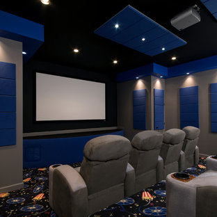 Photo of a contemporary home cinema in Richmond with grey walls, carpet, a projector screen and multi-coloured floors.