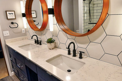 Mid-sized minimalist white tile and ceramic tile porcelain tile and double-sink bathroom photo in Indianapolis with blue cabinets, gray walls, an undermount sink, quartz countertops, a hinged shower door, white countertops and a built-in vanity