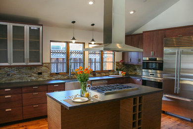 Inspiration for a mid-sized contemporary medium tone wood floor kitchen remodel in San Francisco with a farmhouse sink, flat-panel cabinets, medium tone wood cabinets, glass tile backsplash and stainless steel appliances