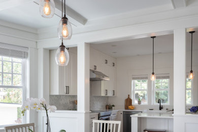 Example of a mid-sized arts and crafts dark wood floor and coffered ceiling dining room design in Seattle with white walls