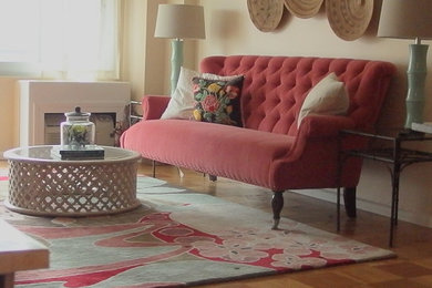 Mid-sized eclectic open concept light wood floor living room photo in New York with beige walls and a wall-mounted tv