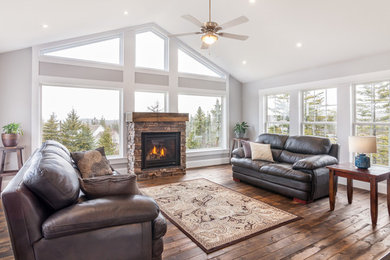 Inspiration for a mid-sized timeless open concept dark wood floor living room remodel in Other with gray walls, a standard fireplace, a stone fireplace and no tv