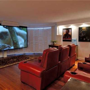 Inspiration for a medium sized classic enclosed home cinema in Hawaii with white walls, medium hardwood flooring and a projector screen.