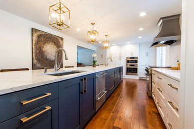 Mid-sized trendy medium tone wood floor kitchen photo in Minneapolis with an undermount sink, shaker cabinets, white cabinets, marble countertops, stainless steel appliances, an island and white countertops