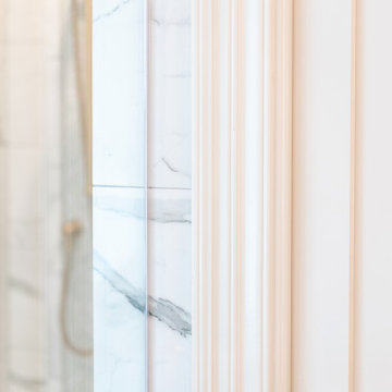 Refined Bathroom Trimwork and Framed Shower View