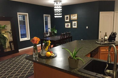 Inspiration for a large contemporary medium tone wood floor and brown floor dining room remodel in Edmonton with blue walls, a standard fireplace and a tile fireplace
