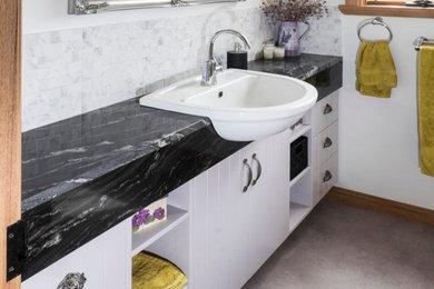 Photo of a bathroom in Hobart with granite benchtops and a drop-in sink.