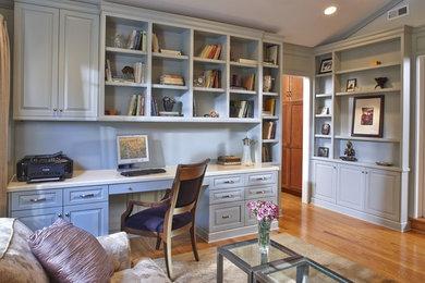 Mid-sized elegant built-in desk medium tone wood floor study room photo in San Francisco with blue walls