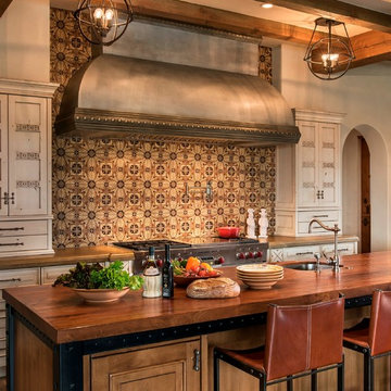 Organic kitchen with custom zinc hood, concrete range countertop, and Mesquite w