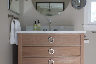 Inspiration for a large transitional master beige tile and porcelain tile ceramic tile and brown floor bathroom remodel in New York with flat-panel cabinets, light wood cabinets, a one-piece toilet, beige walls, an undermount sink, quartz countertops and a hinged shower door