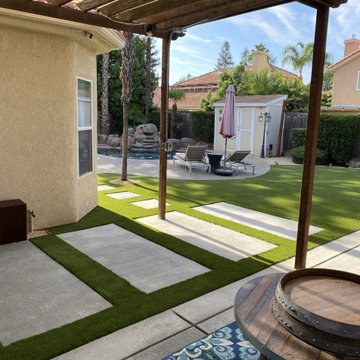 Backyard Demolition with added on Concrete steppingstones and artificial turf de