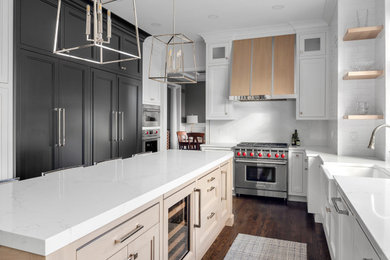 Large trendy u-shaped medium tone wood floor and brown floor eat-in kitchen photo in Detroit with a farmhouse sink, flat-panel cabinets, white cabinets, quartz countertops, white backsplash, ceramic backsplash, paneled appliances, an island and white countertops