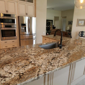Full height back splash ivory kitchen.