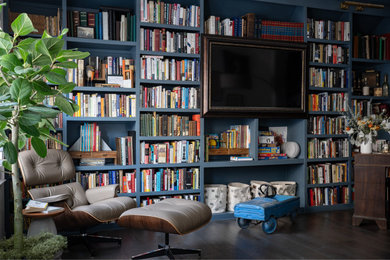 Mid-sized eclectic open concept dark wood floor and brown floor living room library photo in Dallas with blue walls and a media wall
