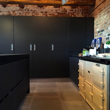 Next 125 Lava black matt glass and matt lacquer with Silestone Arden blue works