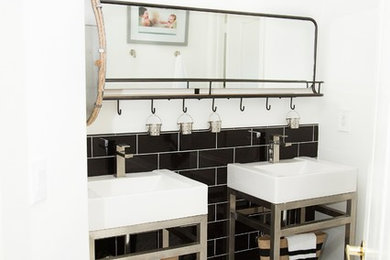 Inspiration for a mid-sized industrial kids' black tile and subway tile porcelain tile and white floor bathroom remodel in Other with a one-piece toilet, white walls, an integrated sink and solid surface countertops